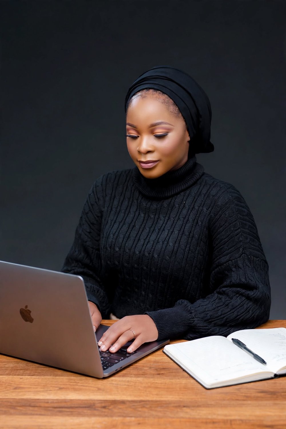 Gomile L. Chimbalanga working on her laptop at her desk