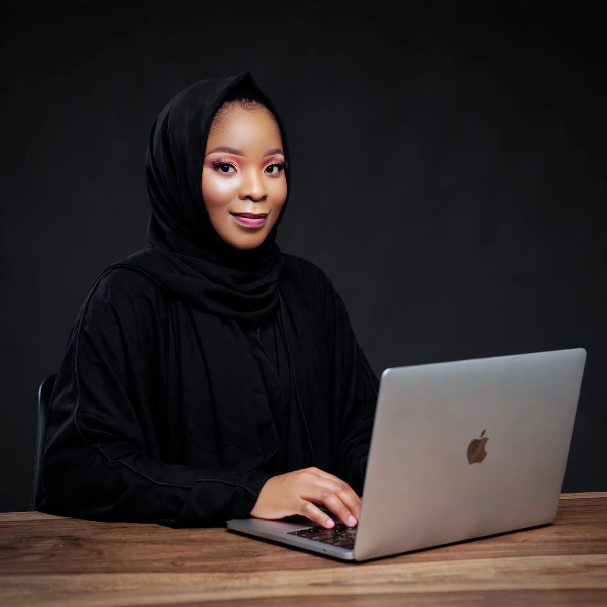 Gomile L. Chimbalanga, software developer in Blantyre, Malawi, working at her laptop